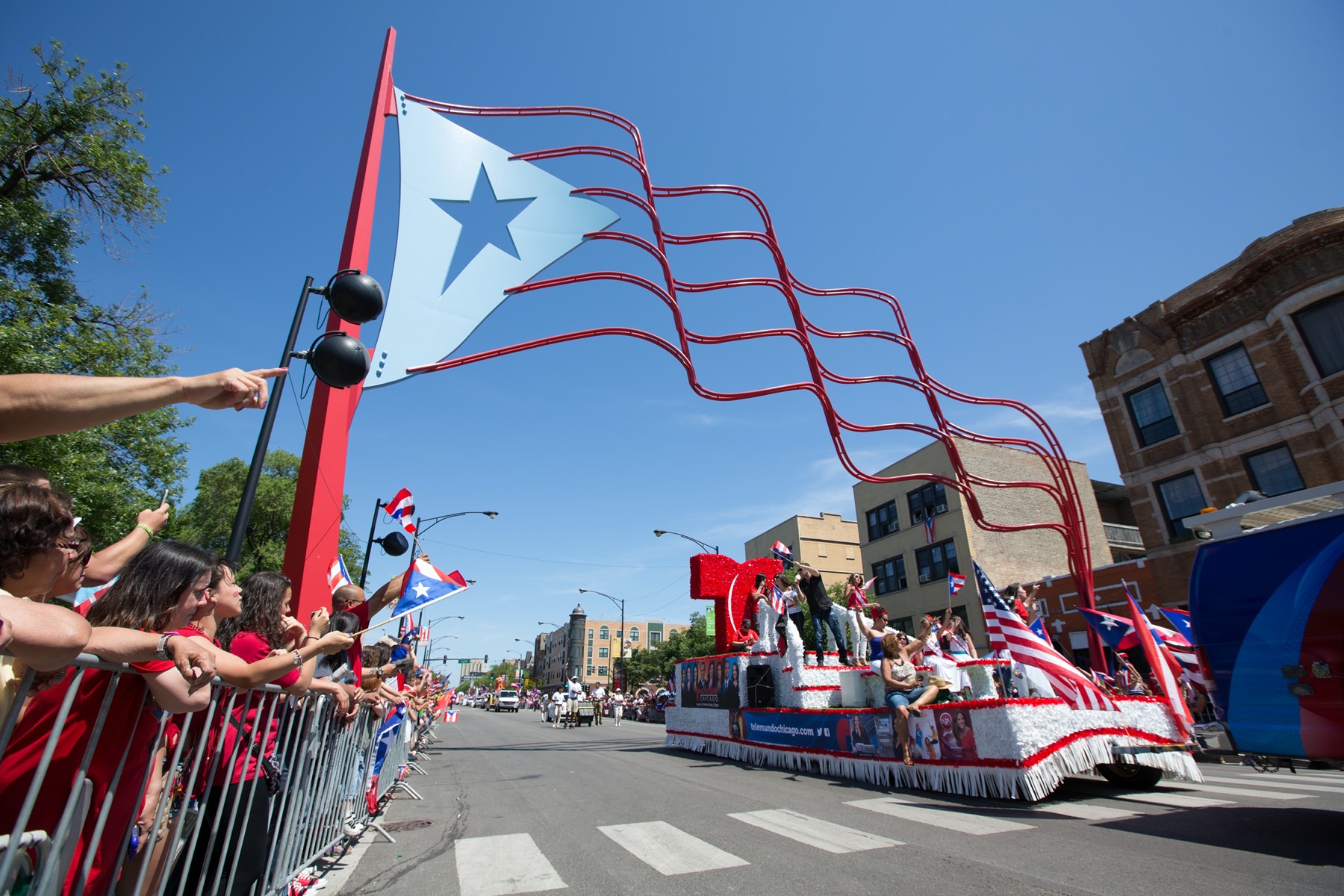 CHICAGO — One of the city's most vibrant cultural celebrations returns this weekend as the Puerto Rican People’s Parade and Festival takes over Humboldt Park, celebrating identity, music, and legacy across generations. Organized by the Puerto Rican Cultural Center, this year’s theme focuses on the “continuity of our culture across generations,” emphasizing the enduring impact of Puerto Rican heritage in Chicago. Parade Begins Saturday, June 8 The Puerto Rican People’s Parade steps off at 2 p.m. Saturday along Division Street, stretching from Western Avenue to Sacramento Avenue. Known as “Paseo Boricua,” the route serves as a symbolic corridor for Puerto Rican culture on the city’s West Side. The parade will feature: Colorful floats and dancers Live music, including salsa and bomba bands Marching groups representing Chicago's Puerto Rican neighborhoods Civic and youth organizations Festival Continues Through Sunday The festival spans two days, from June 8–9, centered around the Humboldt Park boathouse. Attendees can enjoy: Authentic Puerto Rican food vendors serving dishes like mofongo and empanadillas Live entertainment from local and national acts Artisan markets featuring Puerto Rican crafts Family-friendly activities including cultural workshops and games Extra Safety Measures Planned Event organizers have partnered with the Chicago Police Department and local aldermen to ensure a safe environment. Additional patrols, first aid tents, and sanitation stations will be present throughout the event. Street closures begin Friday evening along major parts of Division Street CTA Blue Line and bus routes will offer access to the area Ride shares and cycling encouraged due to limited parking A Message of Resilience and Legacy “We want young Puerto Ricans to see themselves in this legacy,” said a spokesperson from the Puerto Rican Cultural Center. “This is about celebrating our ancestors, our struggles, and our joy.” Humboldt Park has served as a cultural anchor for Puerto Ricans in Chicago since the 1960s, even as the neighborhood faces growing gentrification. This weekend’s celebration reinforces that presence through visibility, community pride, and storytelling. Reader Callout Have you or your family participated in the Puerto Rican People’s Parade in past years? We’d love to feature your stories and memories. Submit them at ChicagoSuburbanFamily.com and let your voice be part of this year’s celebration.